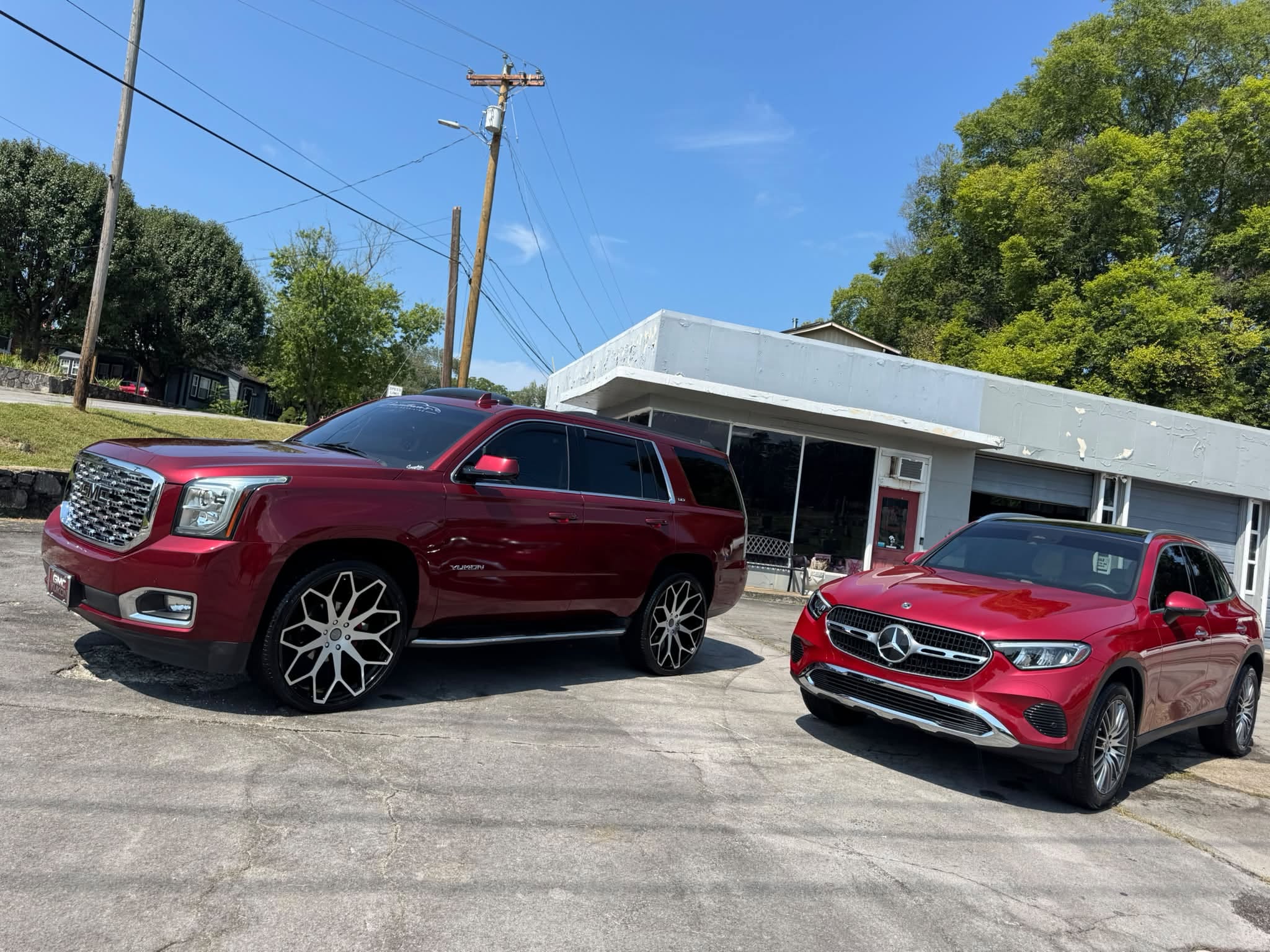 Two polished red vehicles outside Down Town’s Auto Detailing