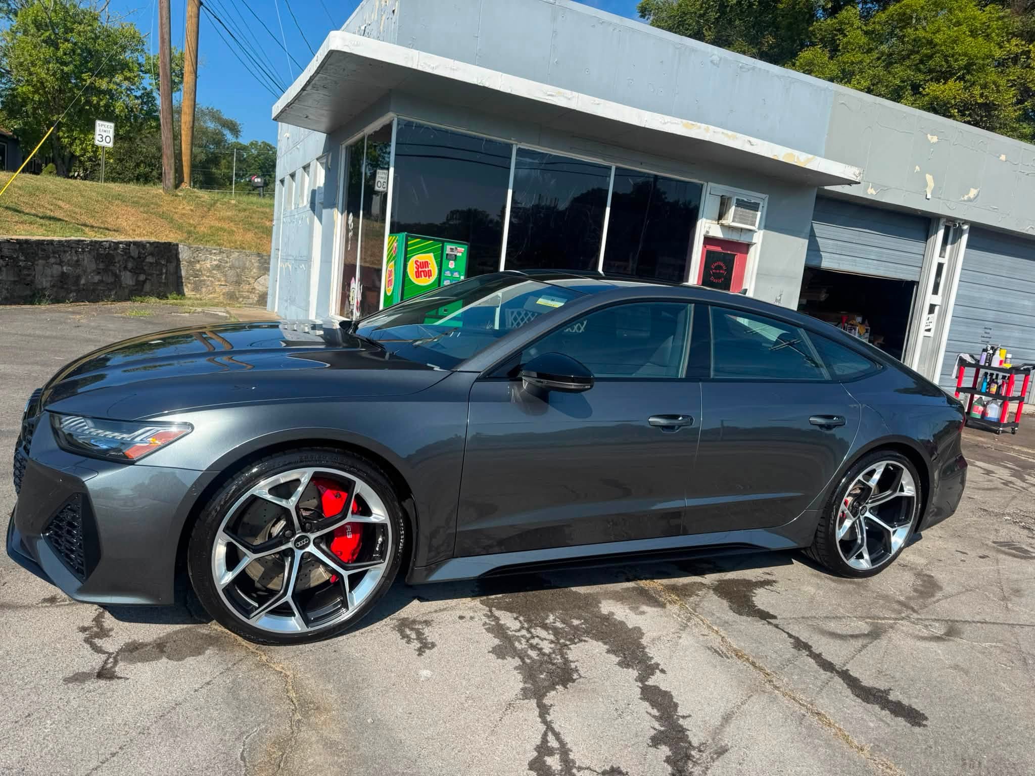 Polished black performance sedan in the sun
