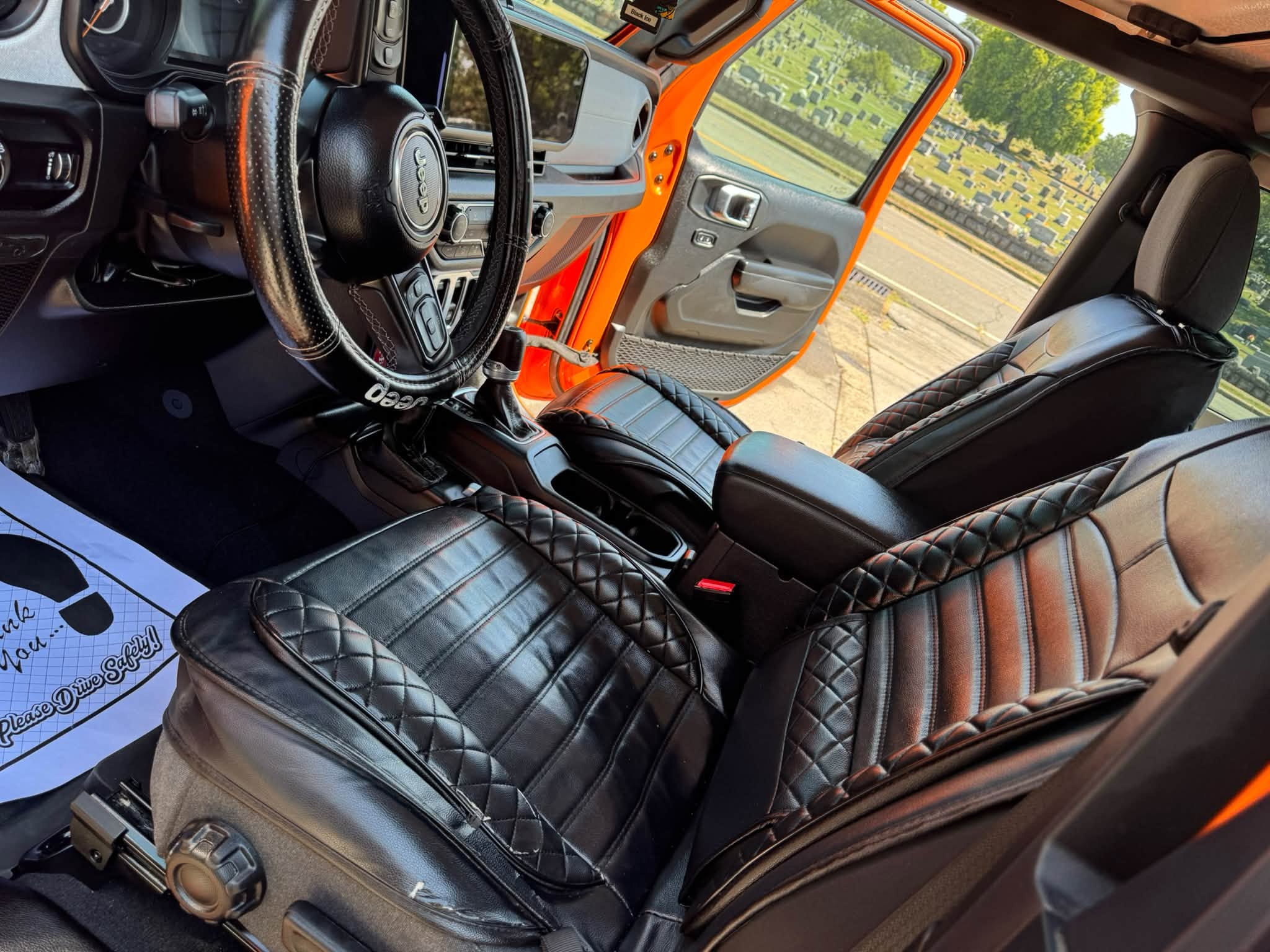 Clean leather interior of an orange Jeep