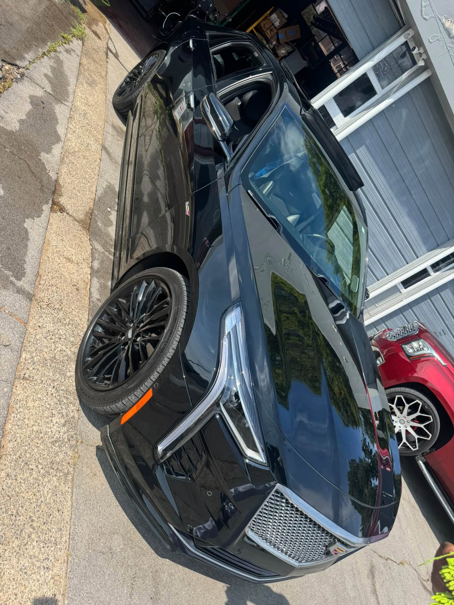 Detailed black Cadillac parked outside